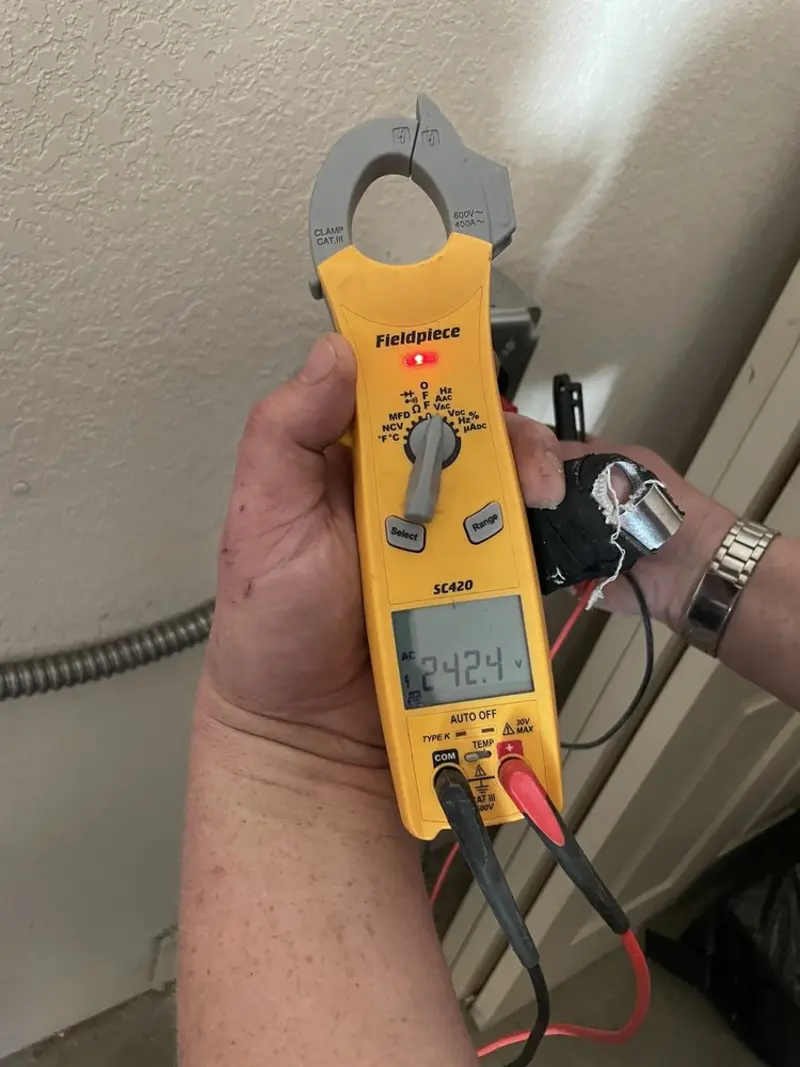 Voltage testing with clamp meter during Electrical Installation Services in Erwin
